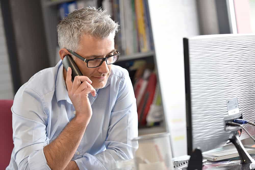 Man on the phone at his desk
