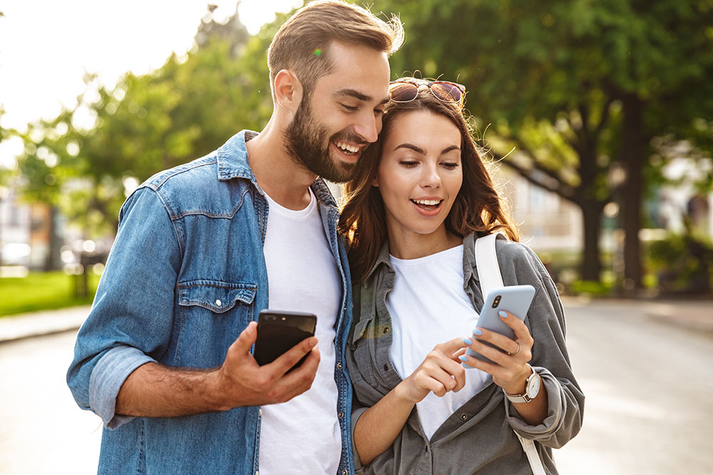 Couple looking at a phone together outdoors