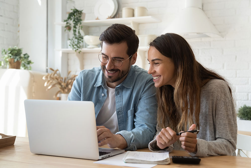 Couple reviewing dental financing options on a laptop