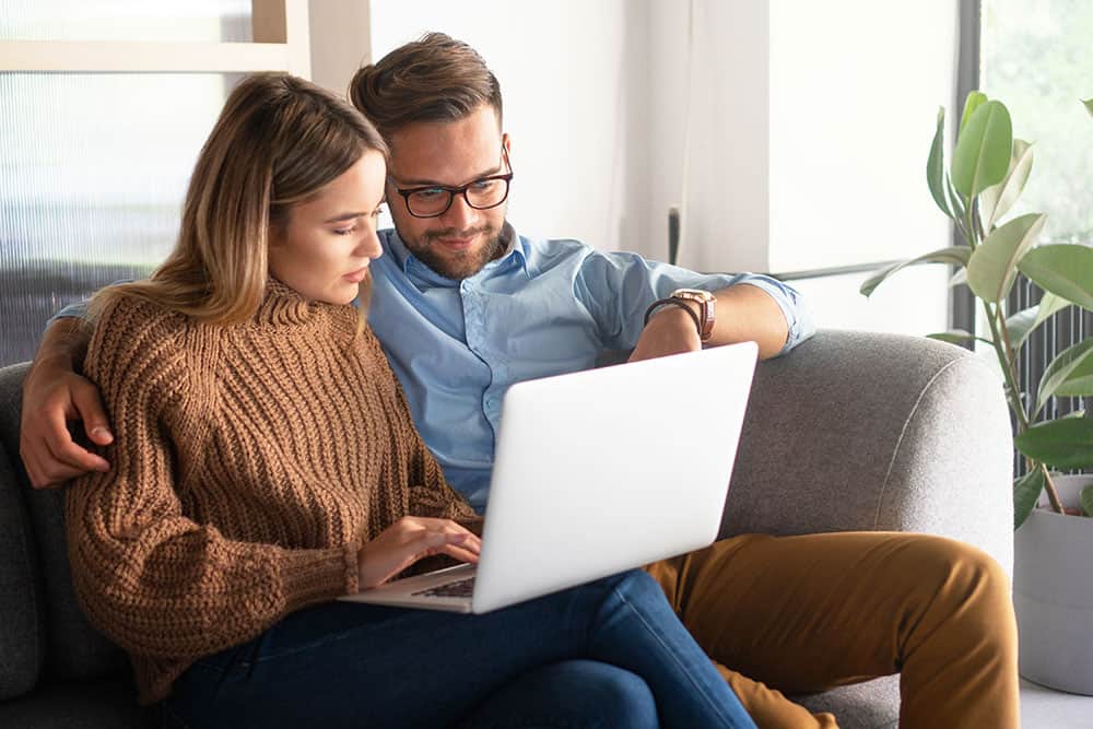Couple looking at a laptop together