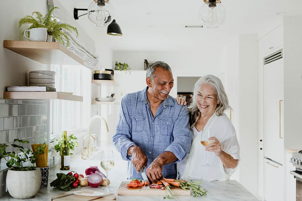Couple preparing a soft meal together while healing after a tooth extraction