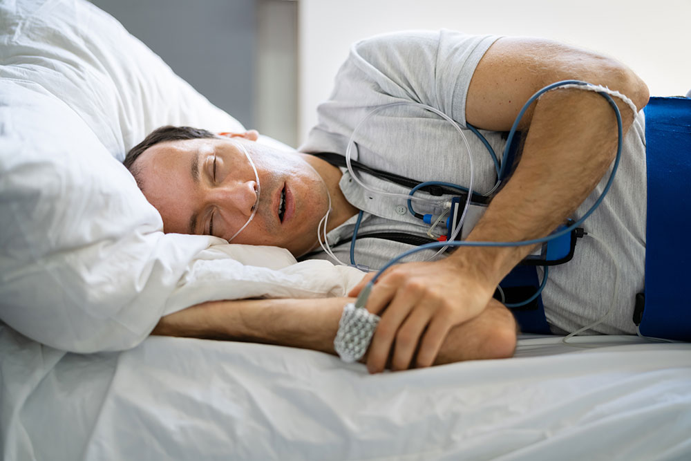 Patient wearing a home sleep apnea test with nasal cannula and sensors