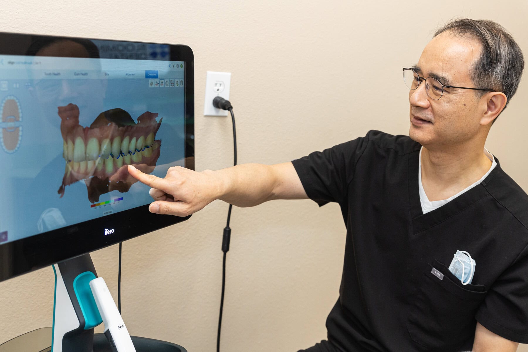 Dr. Yoon reviewing a digital scan while planning a bridge